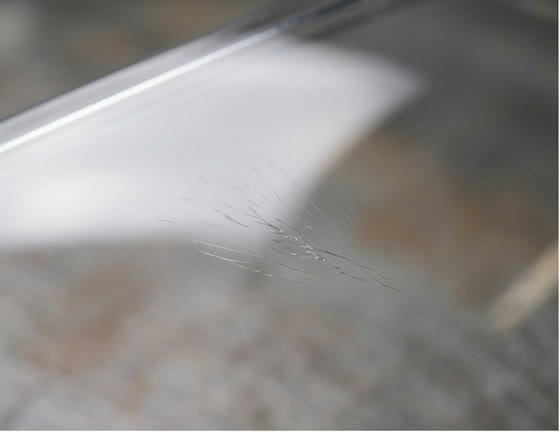 Silver streaking across a clear plastic surface